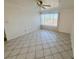 Bright living room with large window, tile floors, ceiling fan, and neutral walls at 2064 Mesquite Ln # 102, Laughlin, NV 89029