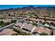 This aerial view shows this home's backyard, neighborhood, and mountain views at 2183 Waterton Rivers Dr, Henderson, NV 89044
