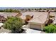 Beautiful aerial view of the single-Gathering home, showcasing the tile roof, desert landscaping, and attached garage at 2183 Waterton Rivers Dr, Henderson, NV 89044