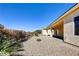 Covered patio and desert landscaping provide a relaxing backyard space at 2183 Waterton Rivers Dr, Henderson, NV 89044
