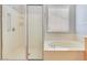 Bright bathroom featuring a soaking tub and separate shower with glass door at 2183 Waterton Rivers Dr, Henderson, NV 89044