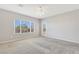 Light-filled bedroom with large window and neutral carpeting and access to backyard at 2183 Waterton Rivers Dr, Henderson, NV 89044