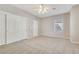 Spacious bedroom with plush carpet, ceiling fan, a closet, and natural light at 2183 Waterton Rivers Dr, Henderson, NV 89044