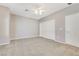 Spacious bedroom with plush carpet, ceiling fan, and a closet at 2183 Waterton Rivers Dr, Henderson, NV 89044