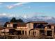 Close up shot of the clubhouse with snow-capped mountains in the distance at 2183 Waterton Rivers Dr, Henderson, NV 89044