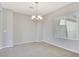 Dining room with neutral carpet, a chandelier, and lots of natural light from the window at 2183 Waterton Rivers Dr, Henderson, NV 89044