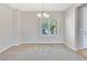 Dining area with neutral walls and carpet, complete with chandelier and window at 2183 Waterton Rivers Dr, Henderson, NV 89044