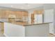 Kitchen with granite countertops, wood cabinets, and a stainless steel sink at 2183 Waterton Rivers Dr, Henderson, NV 89044