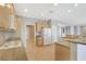 Spacious kitchen featuring wood cabinets, granite countertops, and a full-sized refrigerator at 2183 Waterton Rivers Dr, Henderson, NV 89044