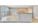Open kitchen with breakfast bar, tile floors and backyard access at 2183 Waterton Rivers Dr, Henderson, NV 89044