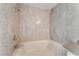 Bathroom featuring a bathtub with updated fixtures and a neutral-toned tile surround at 2200 S Fort Apache Rd # 2015, Las Vegas, NV 89117