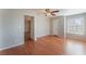This bedroom has wood floors, a ceiling fan, neutral paint and bright natural light from the window at 2200 S Fort Apache Rd # 2015, Las Vegas, NV 89117