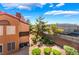 Exterior view of condo featuring manicured backyard landscaping and red tile roof at 2200 S Fort Apache Rd # 2015, Las Vegas, NV 89117