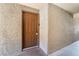 Inviting entryway featuring a solid brown door with modern hardware and textured stucco walls at 2200 S Fort Apache Rd # 2015, Las Vegas, NV 89117