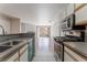Modern kitchen featuring stainless steel appliances, gray countertops, and white cabinets at 2200 S Fort Apache Rd # 2015, Las Vegas, NV 89117