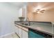 This kitchen boasts a stainless steel sink, gray countertops, and a blue dishwasher at 2200 S Fort Apache Rd # 2015, Las Vegas, NV 89117