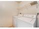 Separate laundry room with washer, dryer, and overhead shelving at 2200 S Fort Apache Rd # 2015, Las Vegas, NV 89117