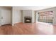 Bright living room with a modern fireplace, wood floors, and a sliding glass door at 2200 S Fort Apache Rd # 2015, Las Vegas, NV 89117