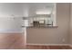 Bright open-concept living space with kitchen, breakfast bar, and wood-style flooring at 2200 S Fort Apache Rd # 2015, Las Vegas, NV 89117