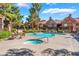 Community pool with spa, lounge seating, landscaping, and building exterior in the background at 2200 S Fort Apache Rd # 2015, Las Vegas, NV 89117