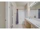 Bright bathroom featuring a double sink vanity and a shower-tub combo with light neutral tile flooring at 2325 Windmill Pkwy # 321, Henderson, NV 89074