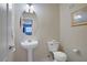 Well-lit half-bathroom featuring a pedestal sink and tiled floors at 2325 Windmill Pkwy # 321, Henderson, NV 89074
