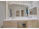 Bright bathroom showcasing a double sink vanity, large mirror with Hollywood lighting, and shower-tub combo at 2325 Windmill Pkwy # 321, Henderson, NV 89074