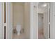 A half-bathroom with a tile floor, white toilet and a white door leading to a closet at 2325 Windmill Pkwy # 321, Henderson, NV 89074