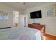 Bedroom with a TV, artwork, ensuite bathroom and direct access to the laundry area at 2325 Windmill Pkwy # 321, Henderson, NV 89074