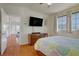Bedroom with hardwood floors, a large screen TV, and bright windows at 2325 Windmill Pkwy # 321, Henderson, NV 89074