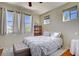 Bright bedroom featuring a queen bed, side tables, and large windows at 2325 Windmill Pkwy # 321, Henderson, NV 89074