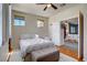 Cozy bedroom with hardwood floors, natural light, and an ottoman at the end of the bed at 2325 Windmill Pkwy # 321, Henderson, NV 89074