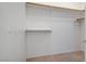 A walk-in closet with white walls, neutral carpet, and shelf and clothing rod for storage at 2325 Windmill Pkwy # 321, Henderson, NV 89074