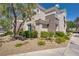 Beautiful condo exterior with rock landscaping, shrubs, and yellow flowers at 2325 Windmill Pkwy # 321, Henderson, NV 89074