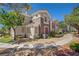 Charming condo exterior featuring a paved walkway and manicured landscaping at 2325 Windmill Pkwy # 321, Henderson, NV 89074