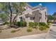 Beautiful condo exterior with rock landscaping, shrubs, and yellow flowers at 2325 Windmill Pkwy # 321, Henderson, NV 89074