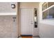Inviting front door with a sidelight and exterior light fixture at 2325 Windmill Pkwy # 321, Henderson, NV 89074