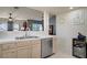Bright kitchen with stainless steel dishwasher and adjacent beverage cooler near living space at 2325 Windmill Pkwy # 321, Henderson, NV 89074