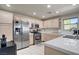 Bright kitchen with stainless steel appliances, tiled countertops, and plenty of natural light at 2325 Windmill Pkwy # 321, Henderson, NV 89074