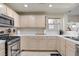 Kitchen featuring stainless steel appliances and white tiled countertops with view to outdoors at 2325 Windmill Pkwy # 321, Henderson, NV 89074