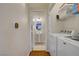 Functional laundry area with washer, dryer, and a view into a half-bathroom at 2325 Windmill Pkwy # 321, Henderson, NV 89074
