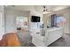 Bright living room with hardwood floors, ceiling fan, fireplace, and view into the Primary bedroom at 2325 Windmill Pkwy # 321, Henderson, NV 89074