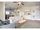 Comfortable living room featuring a white sofa and view into the kitchen at 2325 Windmill Pkwy # 321, Henderson, NV 89074