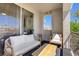 Enjoy outdoor relaxation on this patio with a wrought iron railing, comfortable seating, and palm tree view at 2325 Windmill Pkwy # 321, Henderson, NV 89074