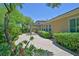 Spacious backyard with lush landscaping, brick patio, and cozy pergola for outdoor enjoyment at 2410 Sunburst View St, Henderson, NV 89052