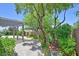 Serene backyard retreat with a covered pergola, brick pathway, and lush landscaping at 2410 Sunburst View St, Henderson, NV 89052