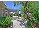 Beautiful backyard featuring a covered pergola, brick pathway, and mature landscaping at 2410 Sunburst View St, Henderson, NV 89052