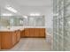 Bright bathroom with double sinks, a soaking tub, and glass block window at 2410 Sunburst View St, Henderson, NV 89052