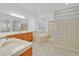 Bathroom featuring double sinks, soaking tub, and a glass block window feature at 2410 Sunburst View St, Henderson, NV 89052