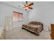 Inviting bedroom features a ceiling fan, neutral carpet, and window with wooden blinds at 2410 Sunburst View St, Henderson, NV 89052
